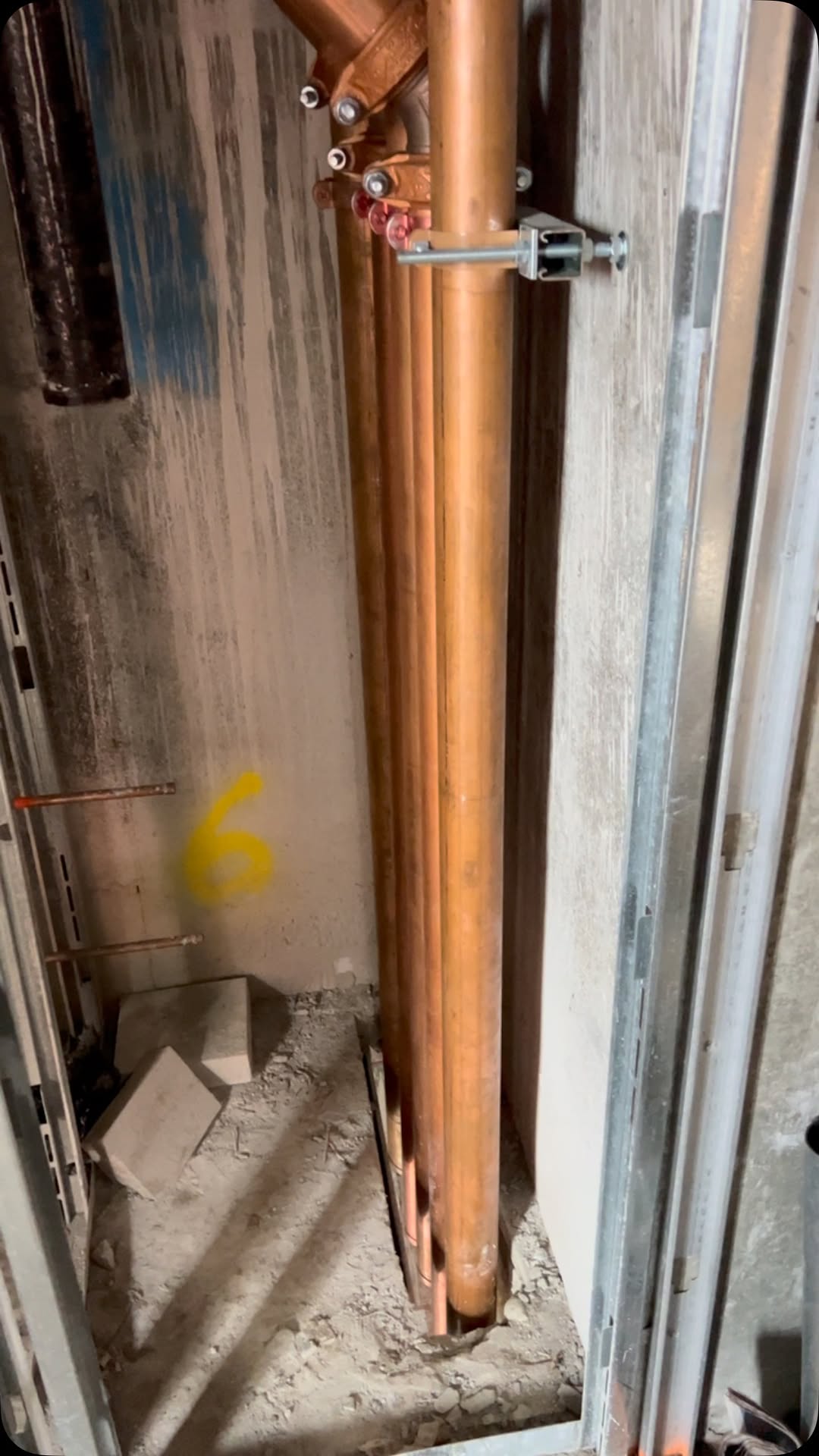 Copper riser stack in an NYC new-construction wall cavity